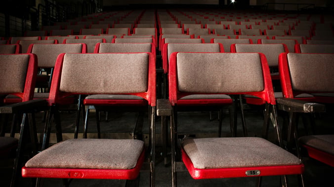 Traditional theater seats lined up in rows
