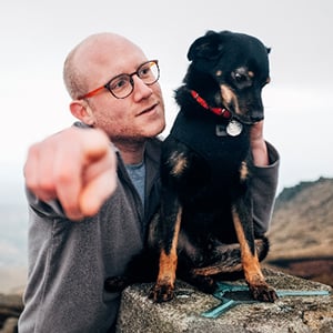 Josh Whelan with his muddy dog Ko-Ko on a mountain walk