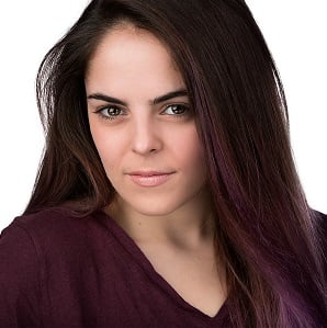 Kyla Tacopina, a woman with straight brown hair, wearing a purple top