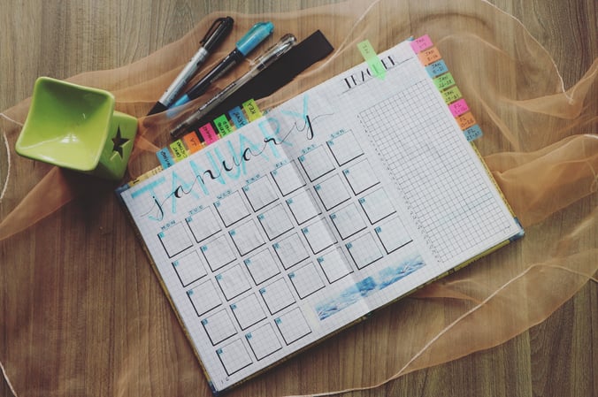 A paper calendar for January, bristling with notes and reminders